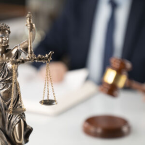 Lady Justice in front, with a judge holding a gavel in the background.